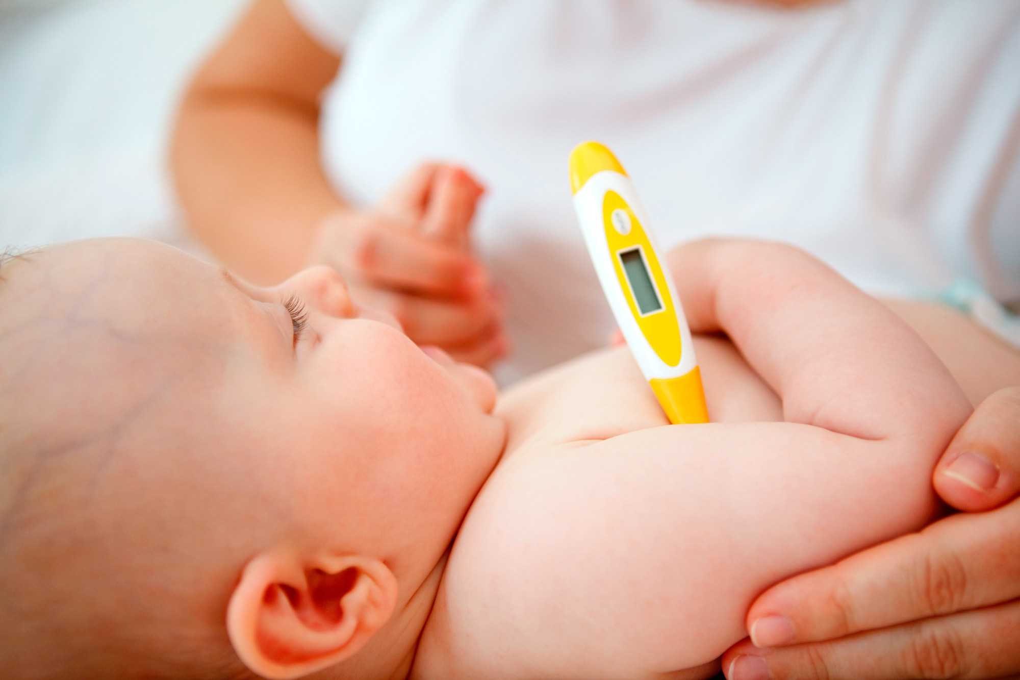 Baby with thermometer under their arm