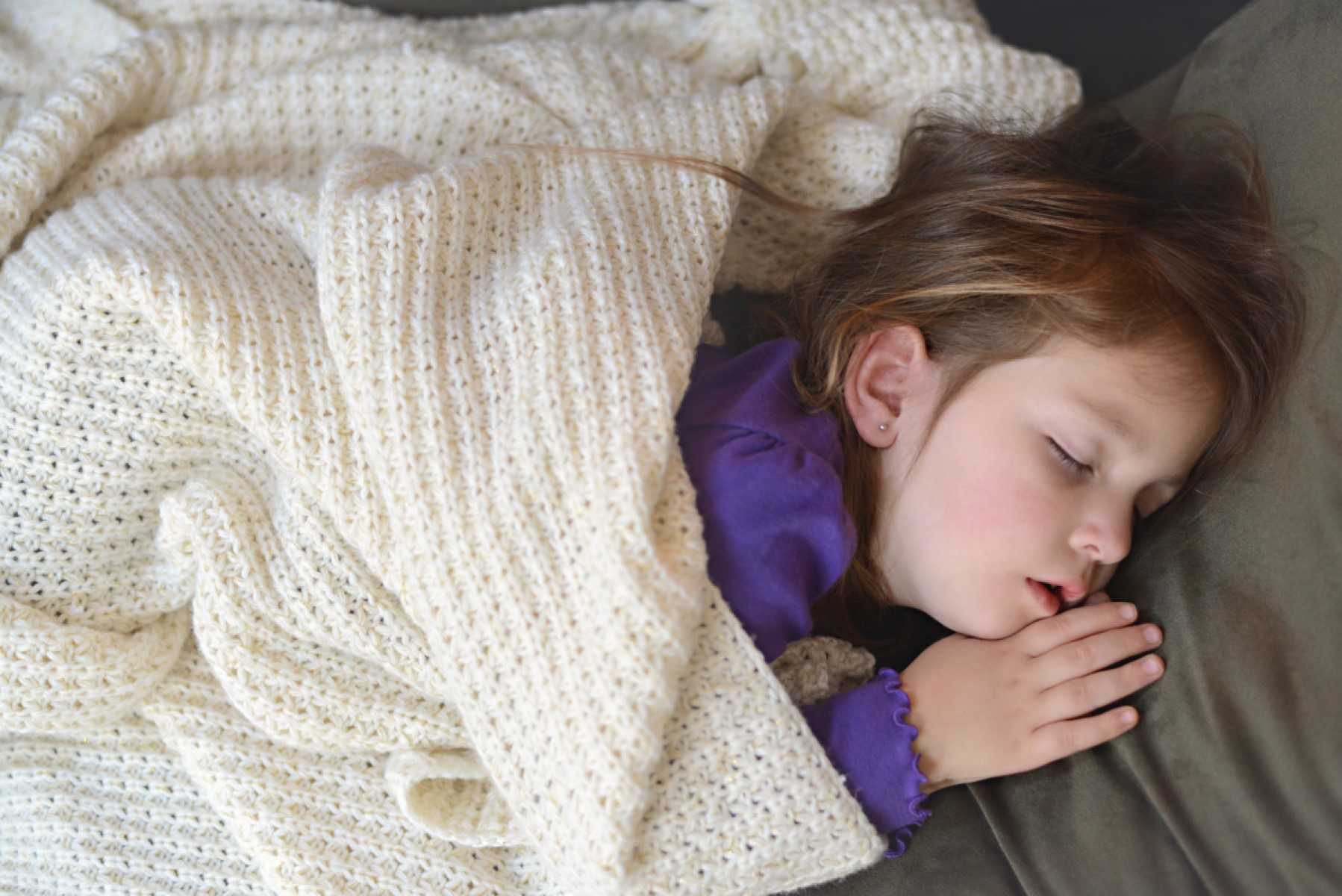 Sleeping child under blanket