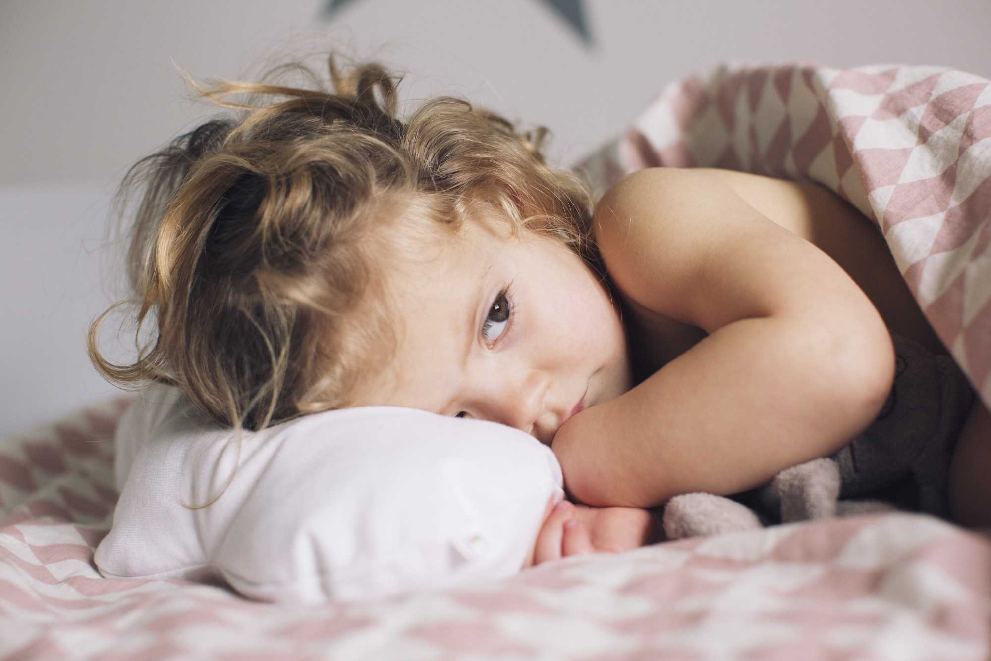Child laying down on pillow