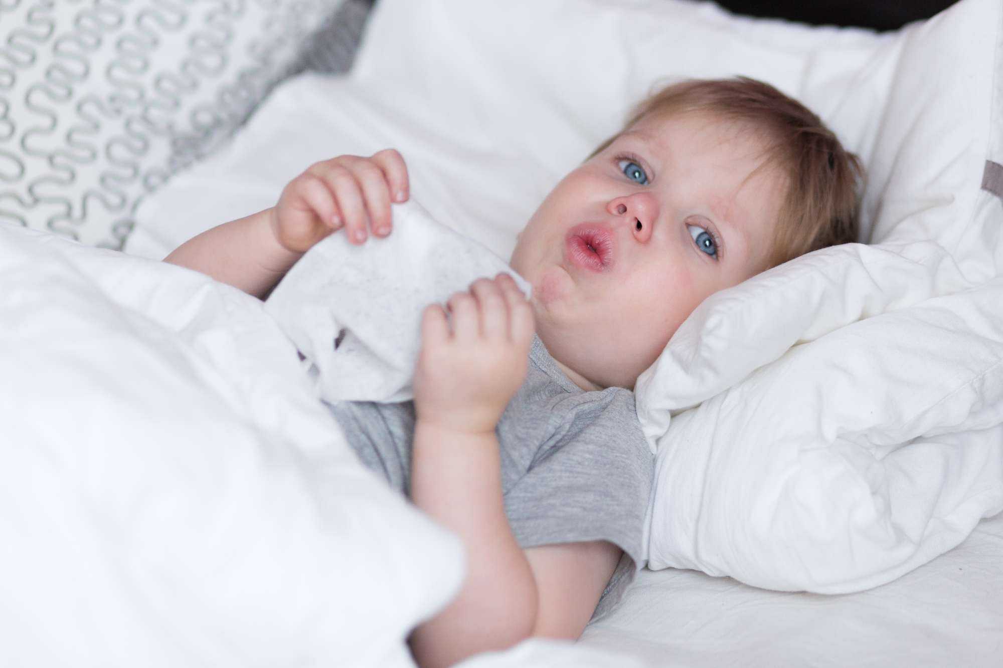 Baby in Bed with Tissue, Coughing