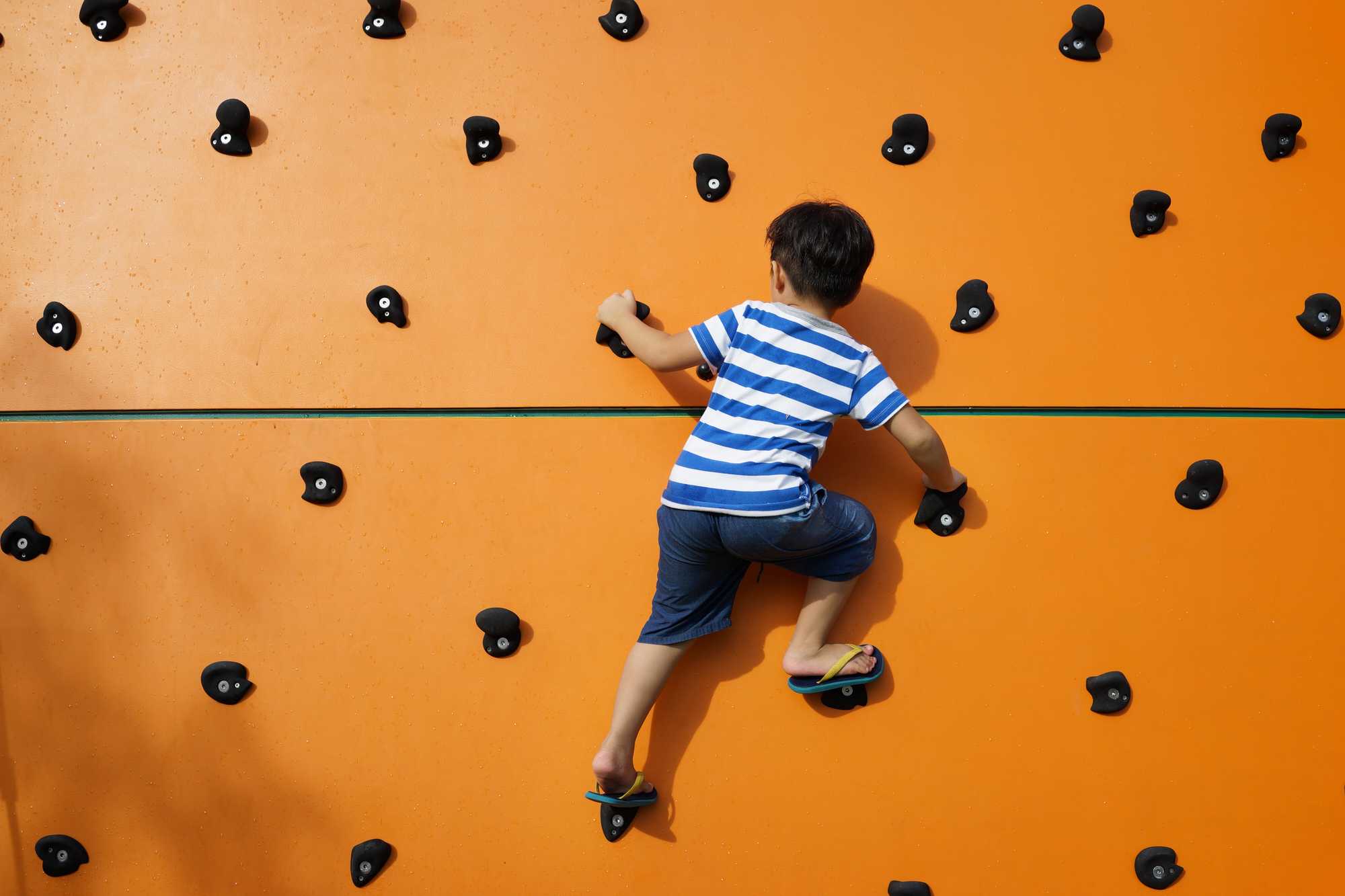 Child climbing on climbing wall
