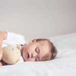 Baby sleeping with plush toy