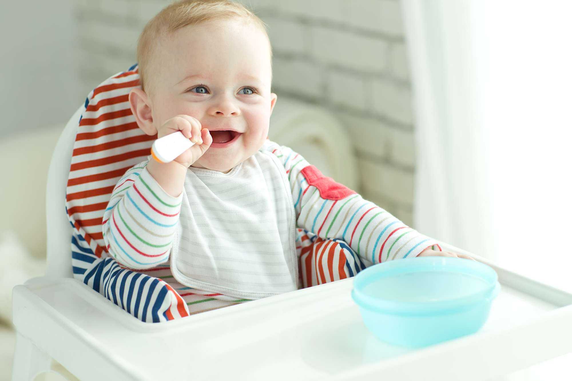  Smiling baby in highchair with spilled food